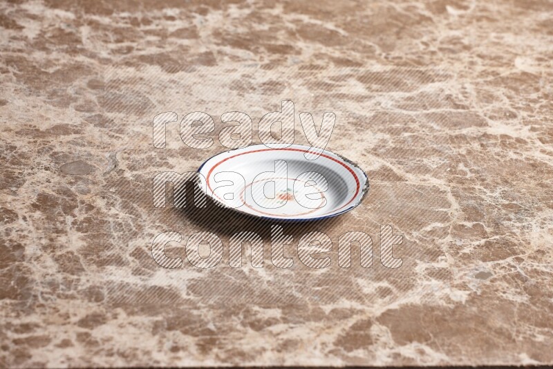 A vintage metal plate on beige marble background