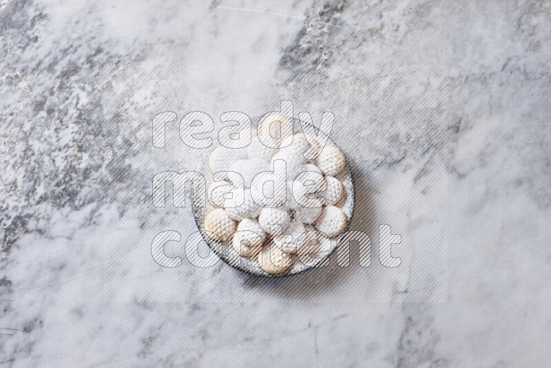 Kahk in black pottery plate on grey marble background