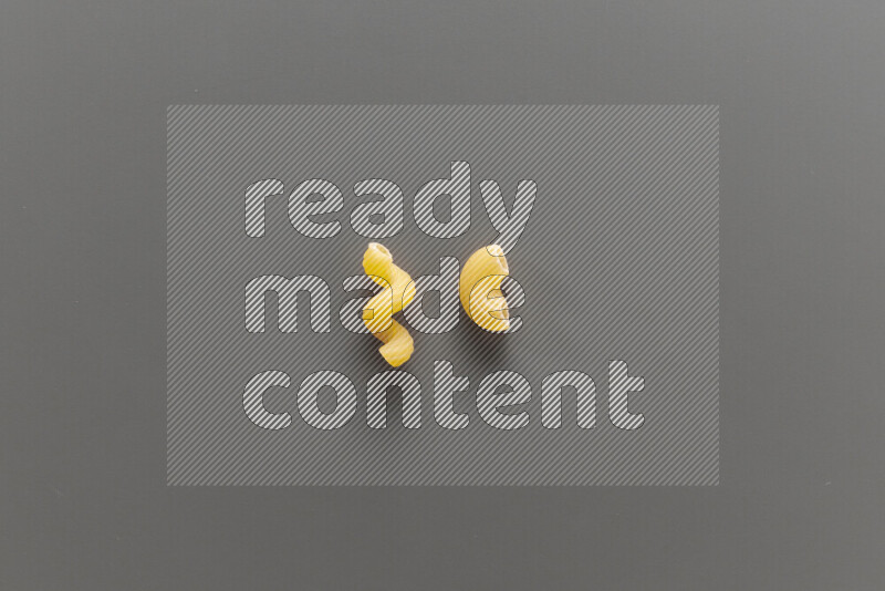 Twist pasta with other types of pasta on grey background