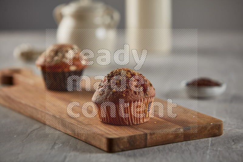 Pistachio cupcake on a wooden board
