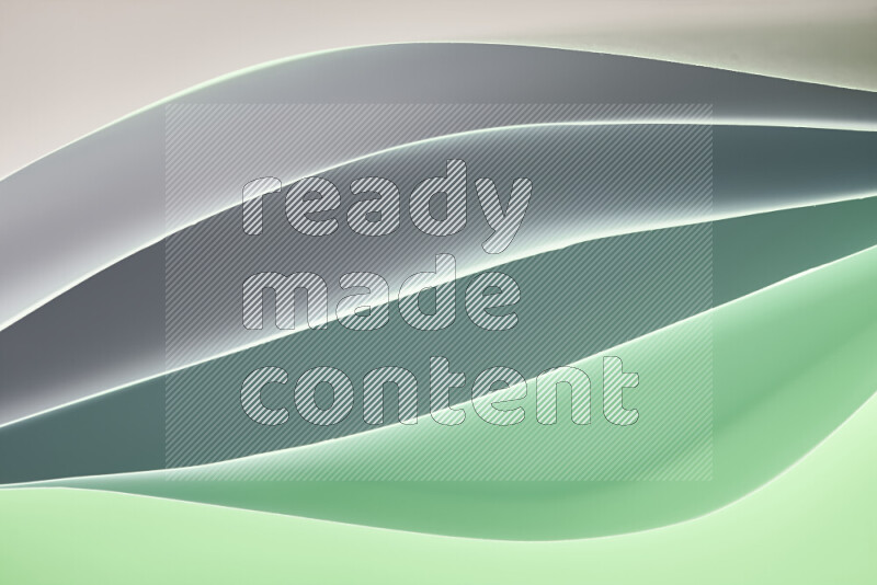 This image showcases an abstract paper art composition with paper curves in green and different warm gradients created by colored light
