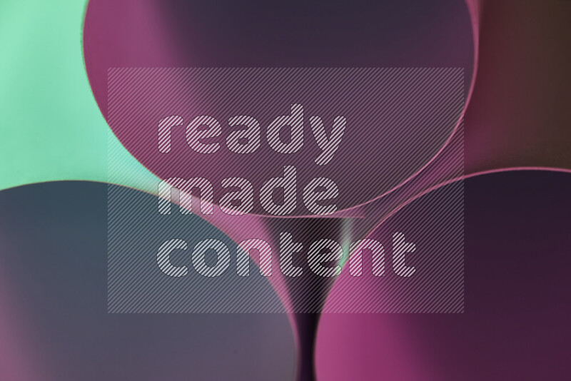 The image shows an abstract paper art with circular shapes in varying shades of green and pink