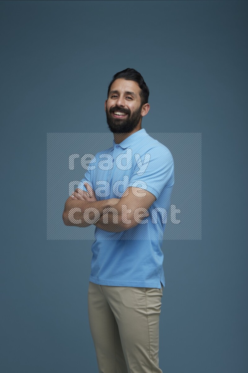 Man posing in a blue background wearing a Blue shirt