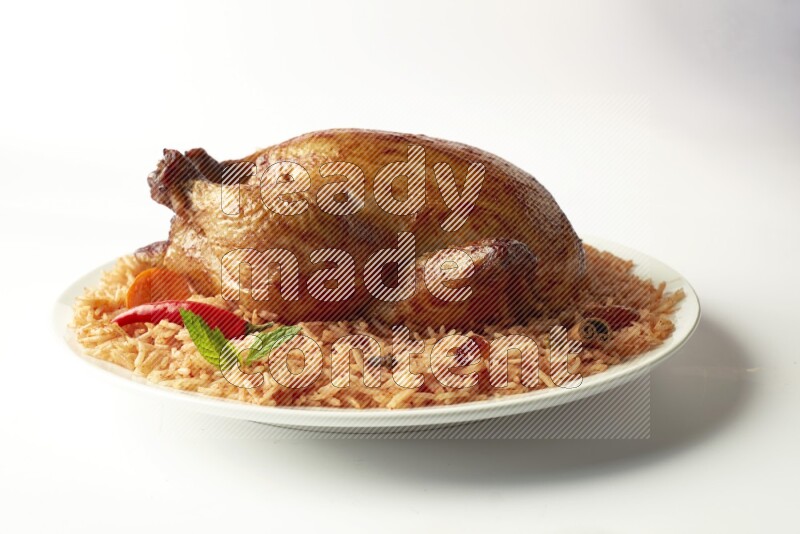 red basmati Rice with  whole roasted chicken on a white rounded plate  direct  on white background