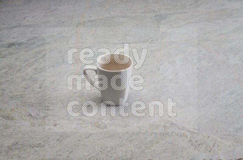A white ceramic mug on grey marble background