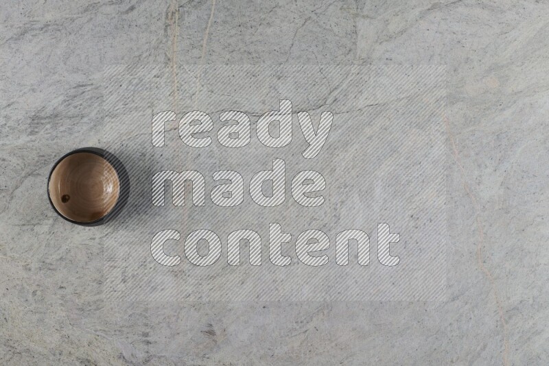 A multicolored pottery Bowl on grey marble background