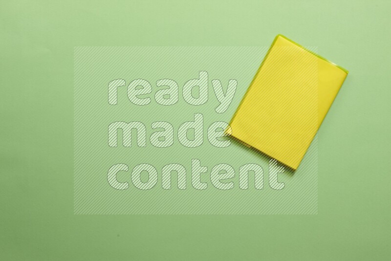 Multicolored notebooks on green background