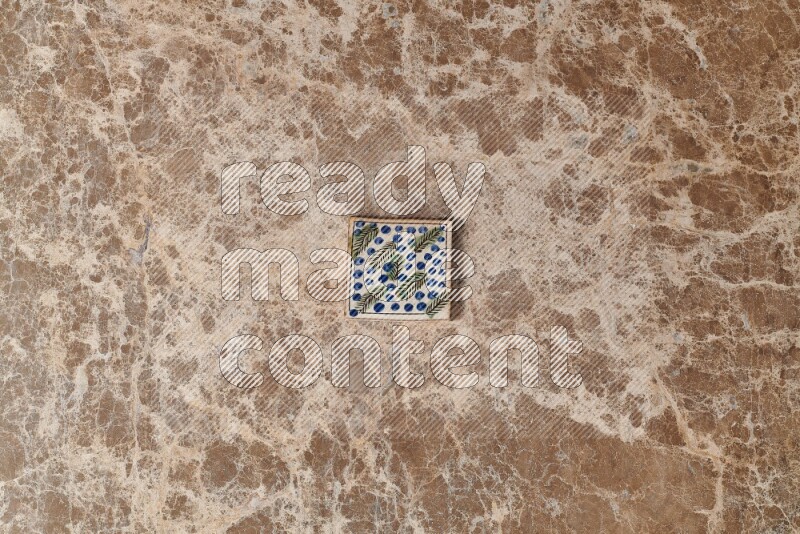 A decorative coaster on beige marble background