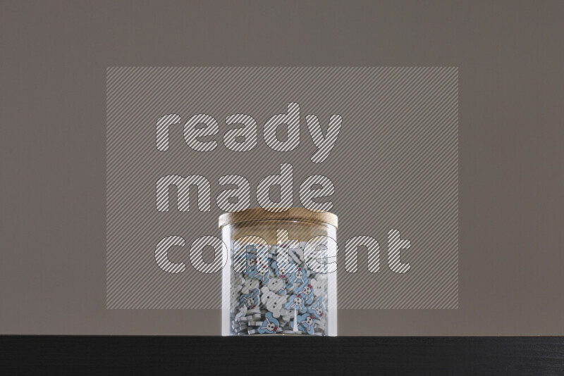 Buttons in a glass jar on black background