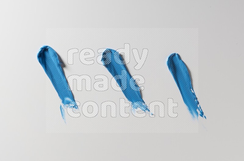 Blue painting knife strokes on white background