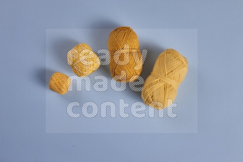 A yellow collection of sewing and tailoring tools arranged on a blue background