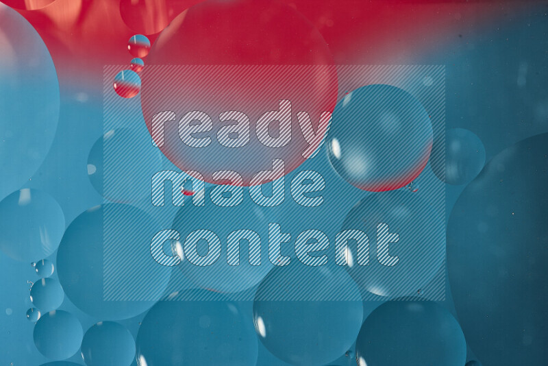 Close-ups of abstract oil bubbles on water surface in shades of blue and pink