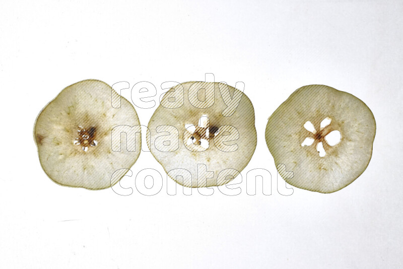 Pear slices on illuminated white background