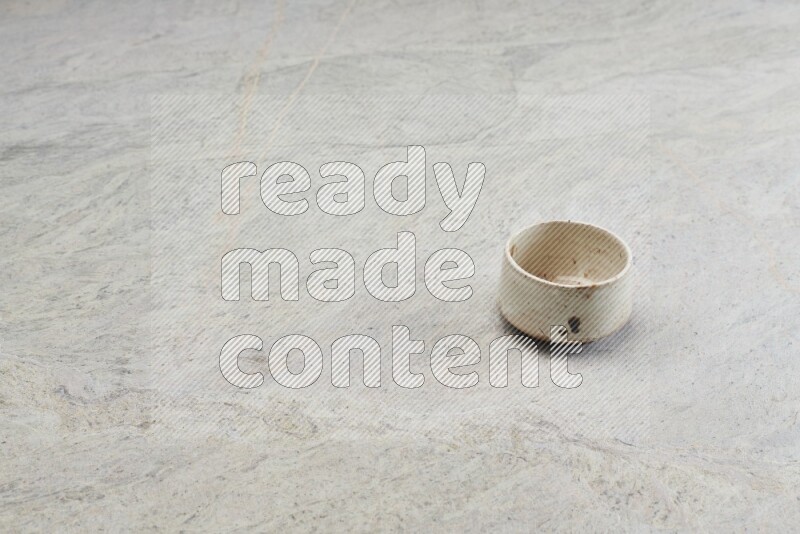 A multicolored pottery bowl on grey marble background