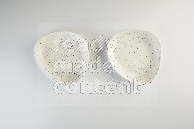 white plate with black dots on white background