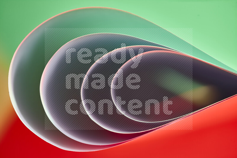An abstract art of paper folded into smooth curves in green and red gradients