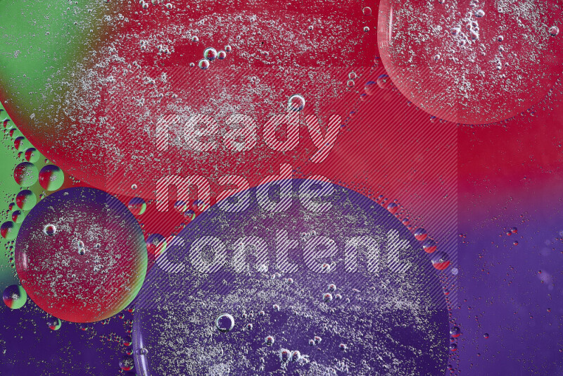 Close-ups of abstract oil bubbles on water surface in shades of purple, green and red