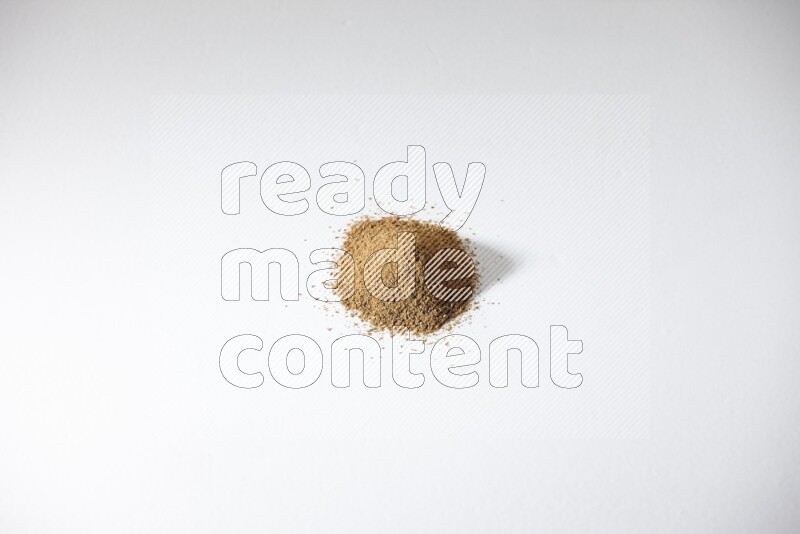 Cumin powder on white flooring
