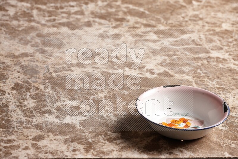 A vintage metal plate on beige marble background