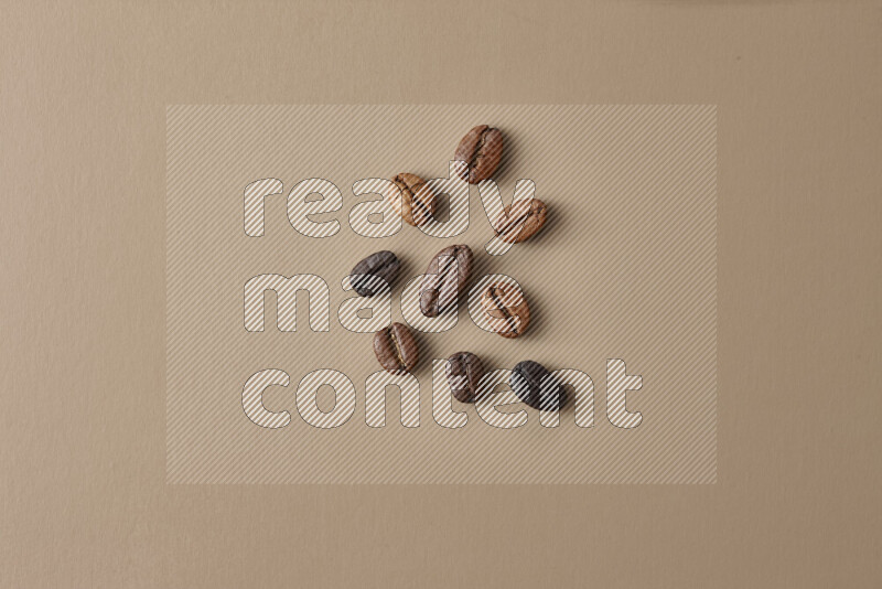 Roasted coffee beans on beige background