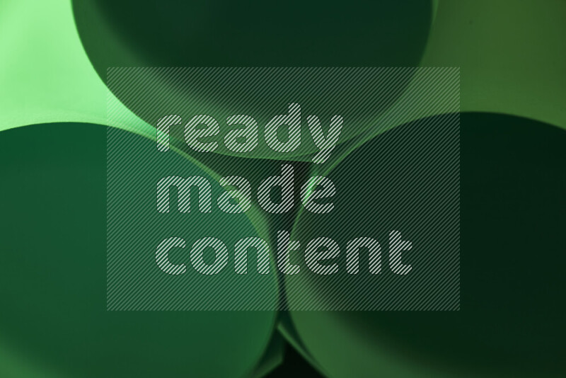 The image shows an abstract paper art with circular shapes in varying shades of green