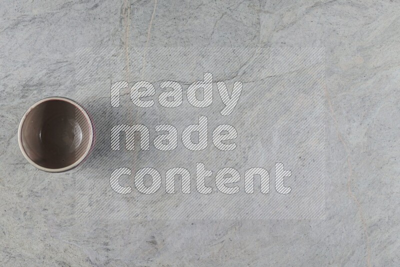 A multicolored pottery Bowl on grey marble background