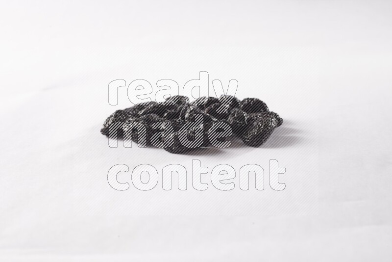 Dried plums on white background