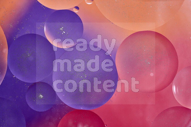 Close-ups of abstract oil bubbles on water surface in shades of red, orange and purple