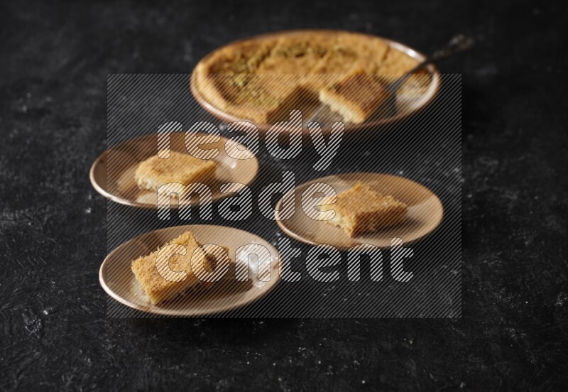 Konafa in different plates in a dark setup