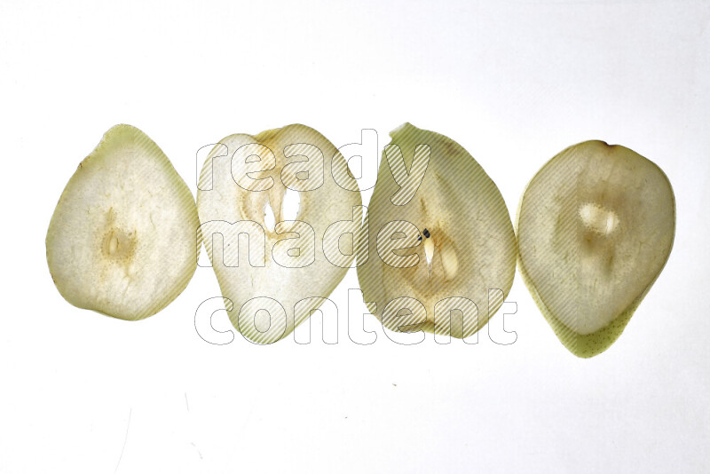 Pear slices on illuminated white background