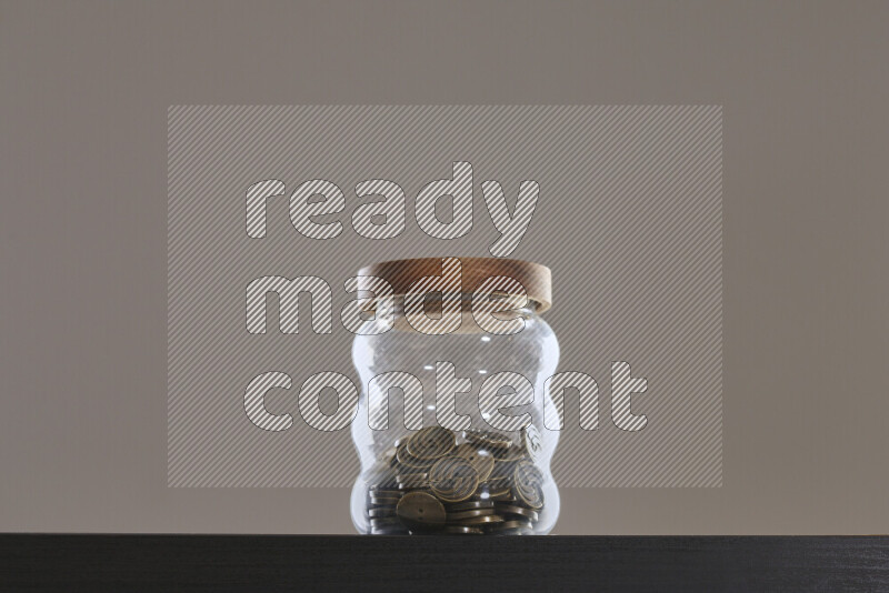 Buttons in a glass jar on black background