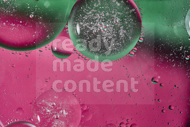 Close-ups of abstract oil bubbles on water surface in shades of green and pink