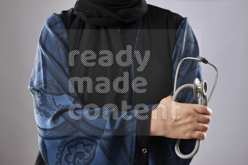 Female doctor wearing an abaya and medical attire in different positions