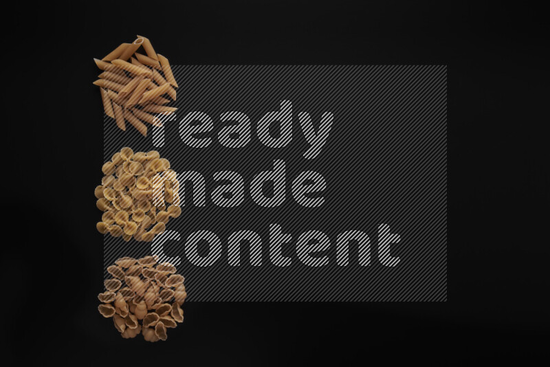 Different pasta types in 3 bunches on black background