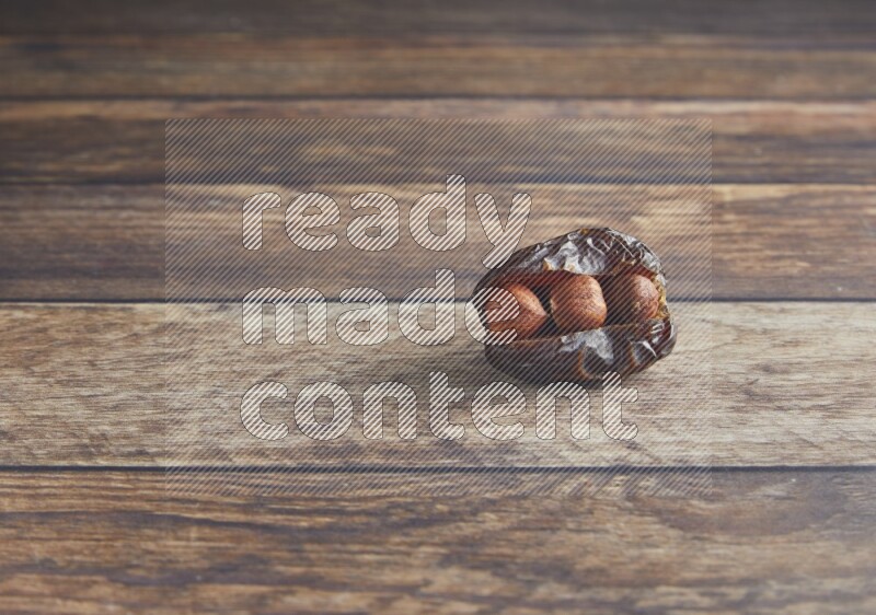 hazelnut stuffed madjoul date on a wooden background
