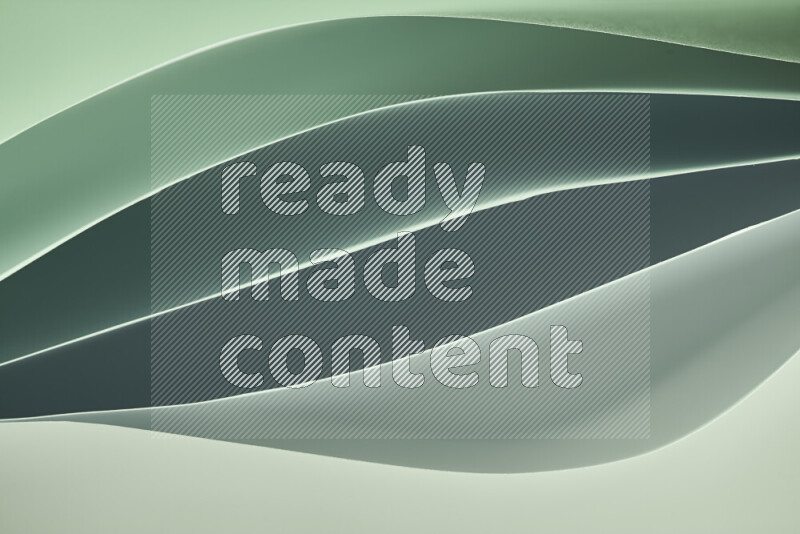 This image showcases an abstract paper art composition with paper curves in green gradients created by colored light