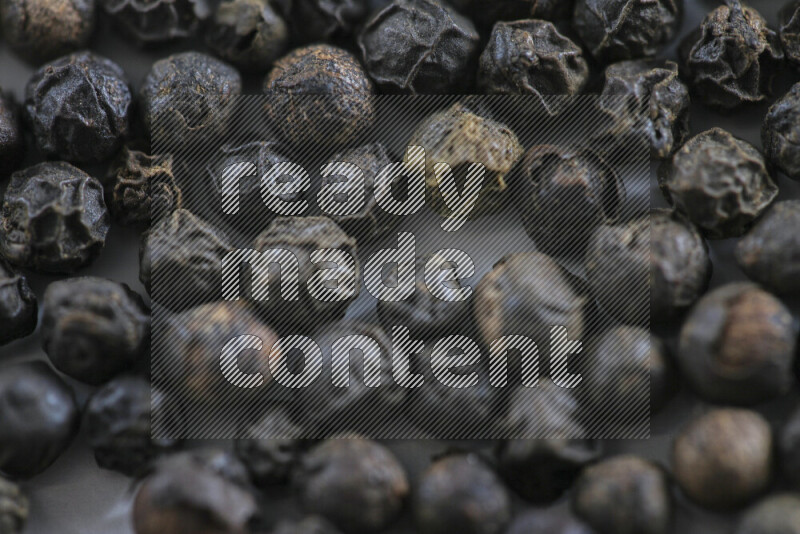 Black pepper beads on white background