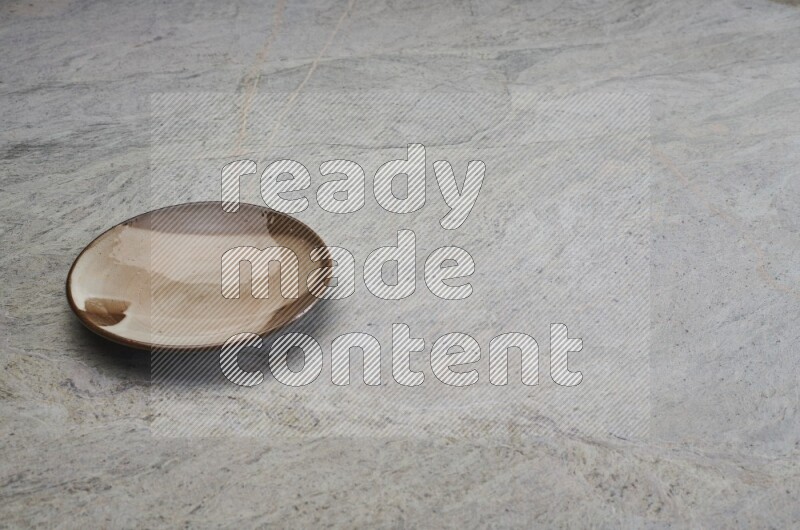 Multicolored Pottery Plate On Grey Marble Flooring