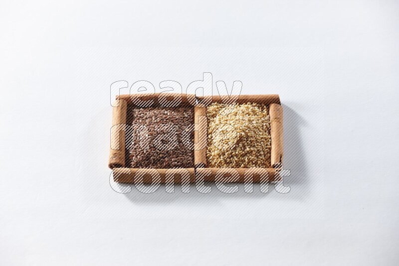 2 squares of cinnamon sticks full of flaxseeds and sesame on white flooring