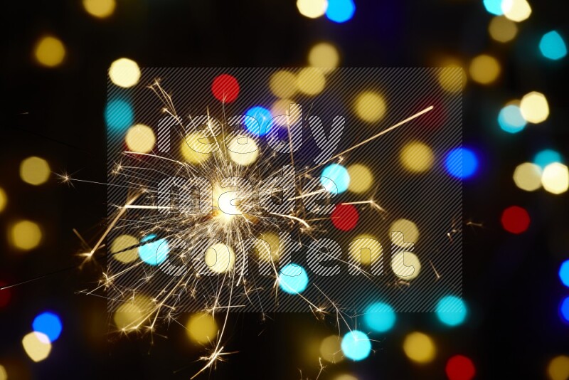Sparkler candles with multicolored light bokeh background
