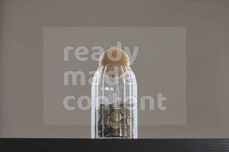 Buttons in a glass jar on black background