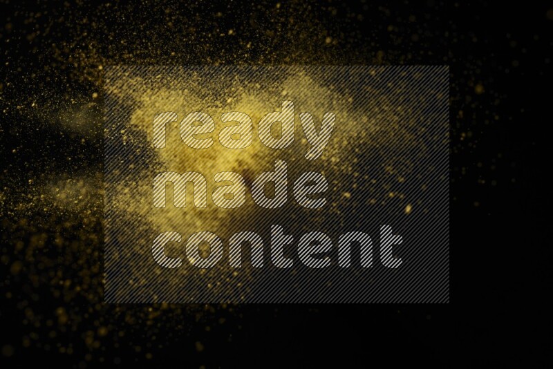 Yellow powder explosion on black background