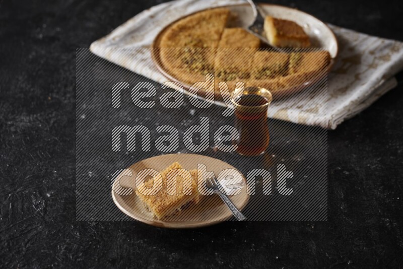 konafa with tea in a dark setup