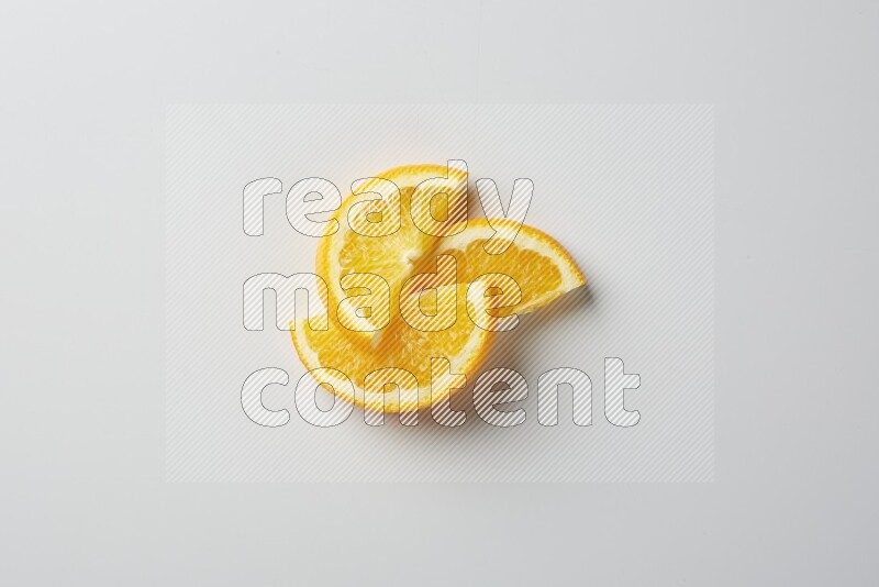 Three halves of an orange slices on white background