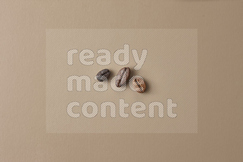 Roasted coffee beans on beige background
