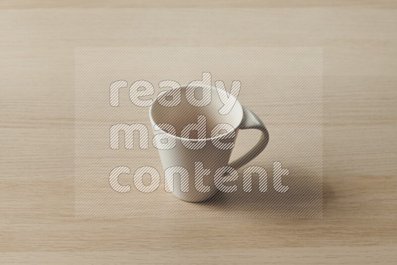 A white ceramic mug on light wooden background