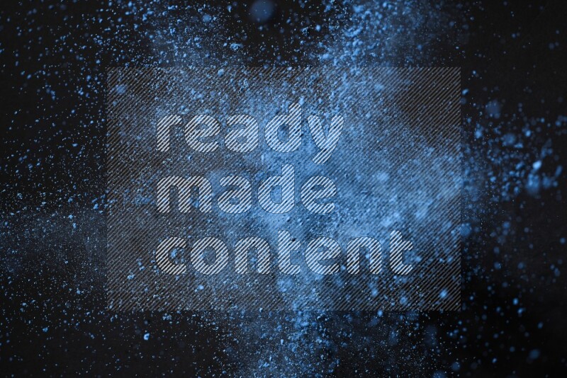 Blue powder explosion on black background