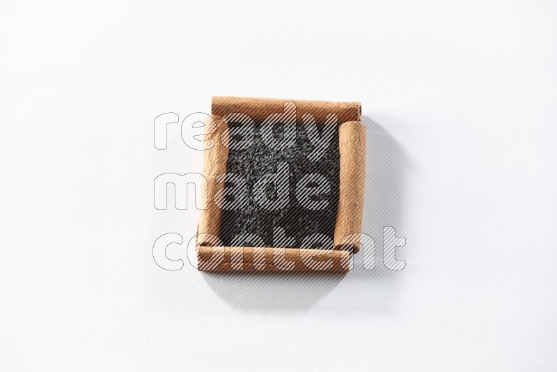 A single square of cinnamon sticks full of black seeds on white flooring