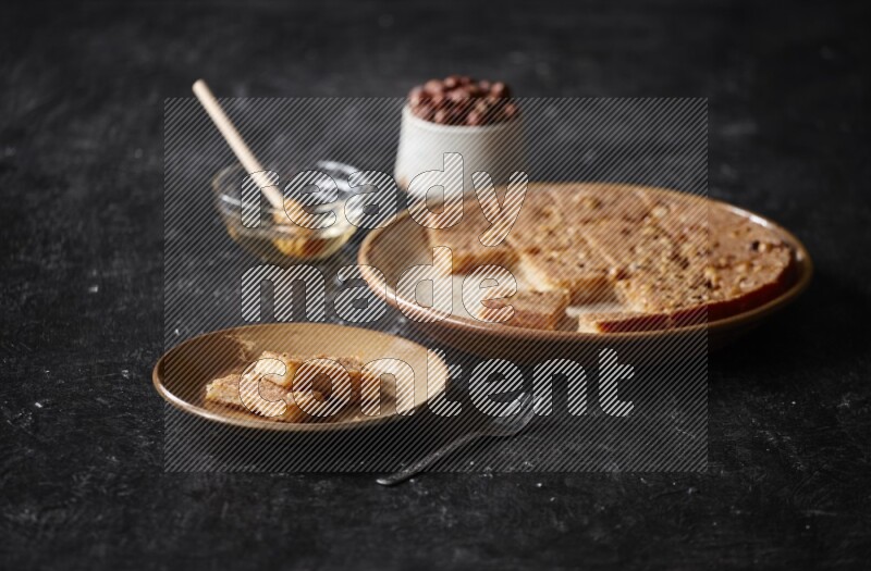 Basbousa with nuts and honey in a dark setup