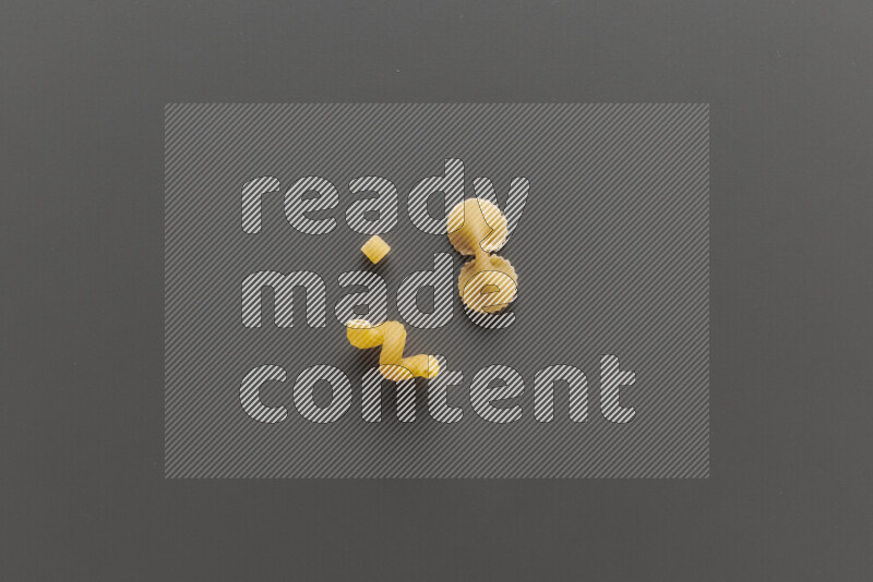 Different pasta types on grey background